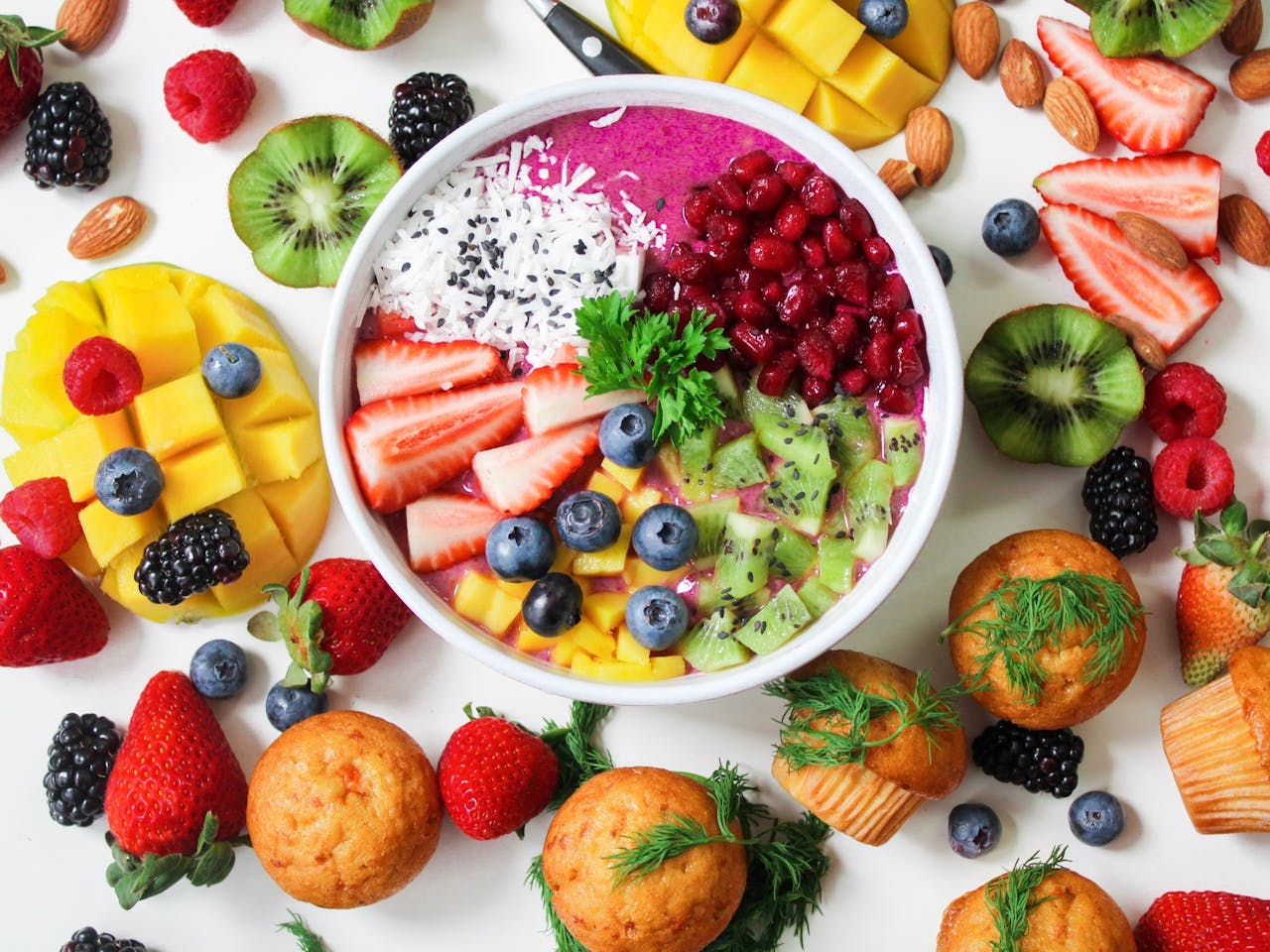 portfolio-01 Vibrant smoothie bowl topped with assorted fresh fruits and muffins, perfect for a healthy snack.